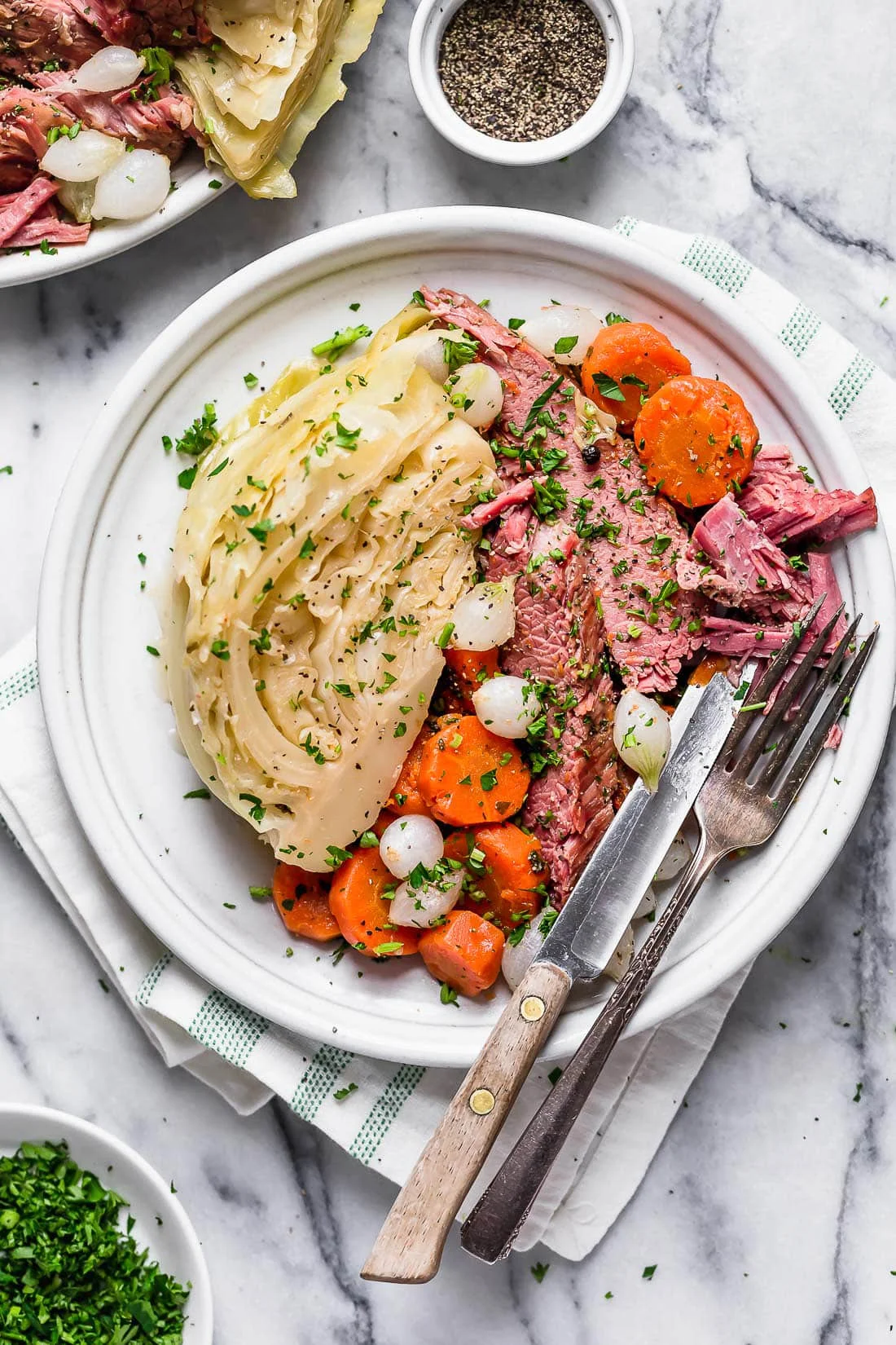 Overhead view of a plate of corned beef and cabbage with carrots