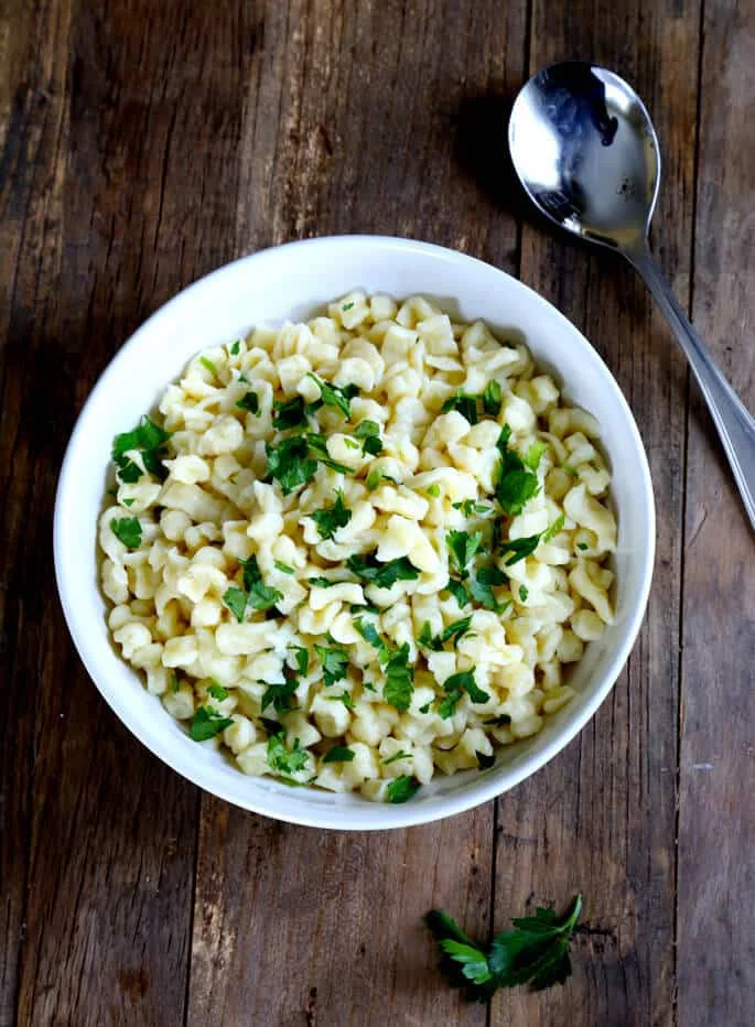 Overhead view of a white bowl with gluten free spaetzle in it