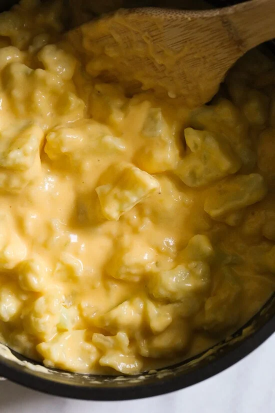 Overhead view of cheesy cauliflower mac and cheese in a pot.