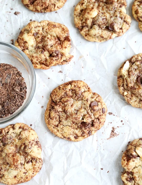 Overhead view of chocolate chip cookies on white surface.