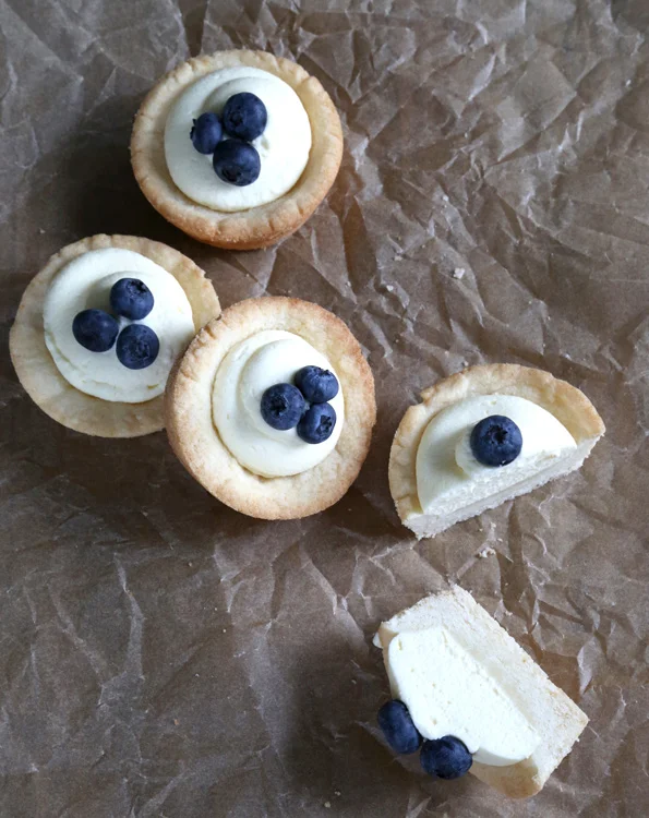 Overhead view of cookie cups with cheesecake filling and blueberries