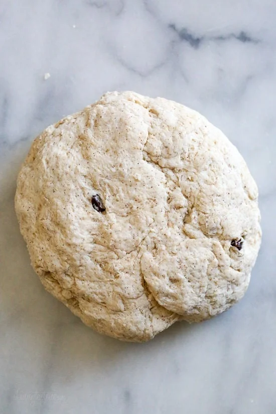 Overhead view of homemade hot cross bun dough on a countertop.