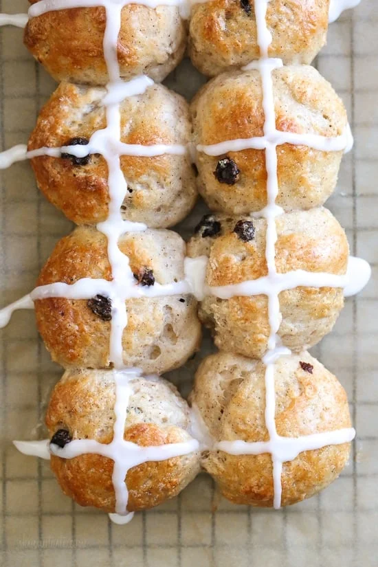 Overhead view of hot cross buns topped with icing.