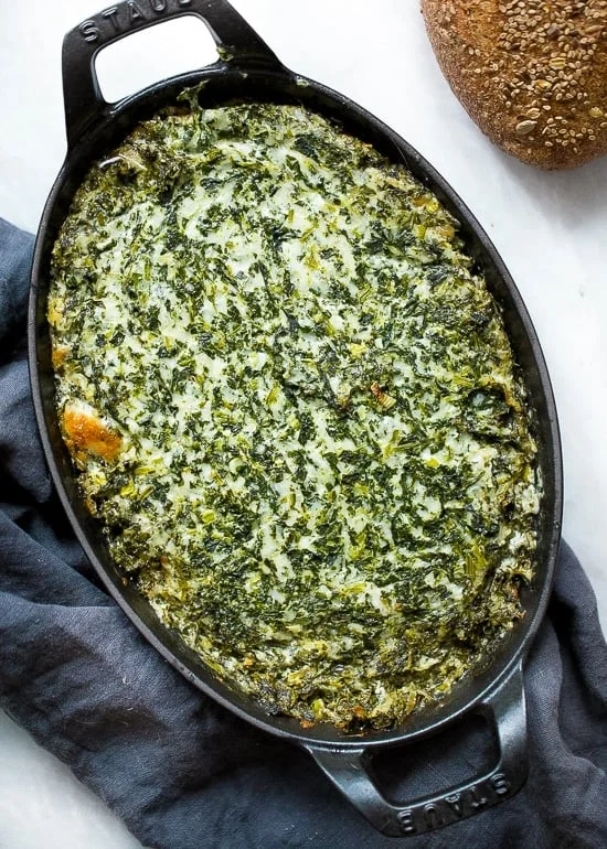 Overhead view of hot spinach dip in baking dish