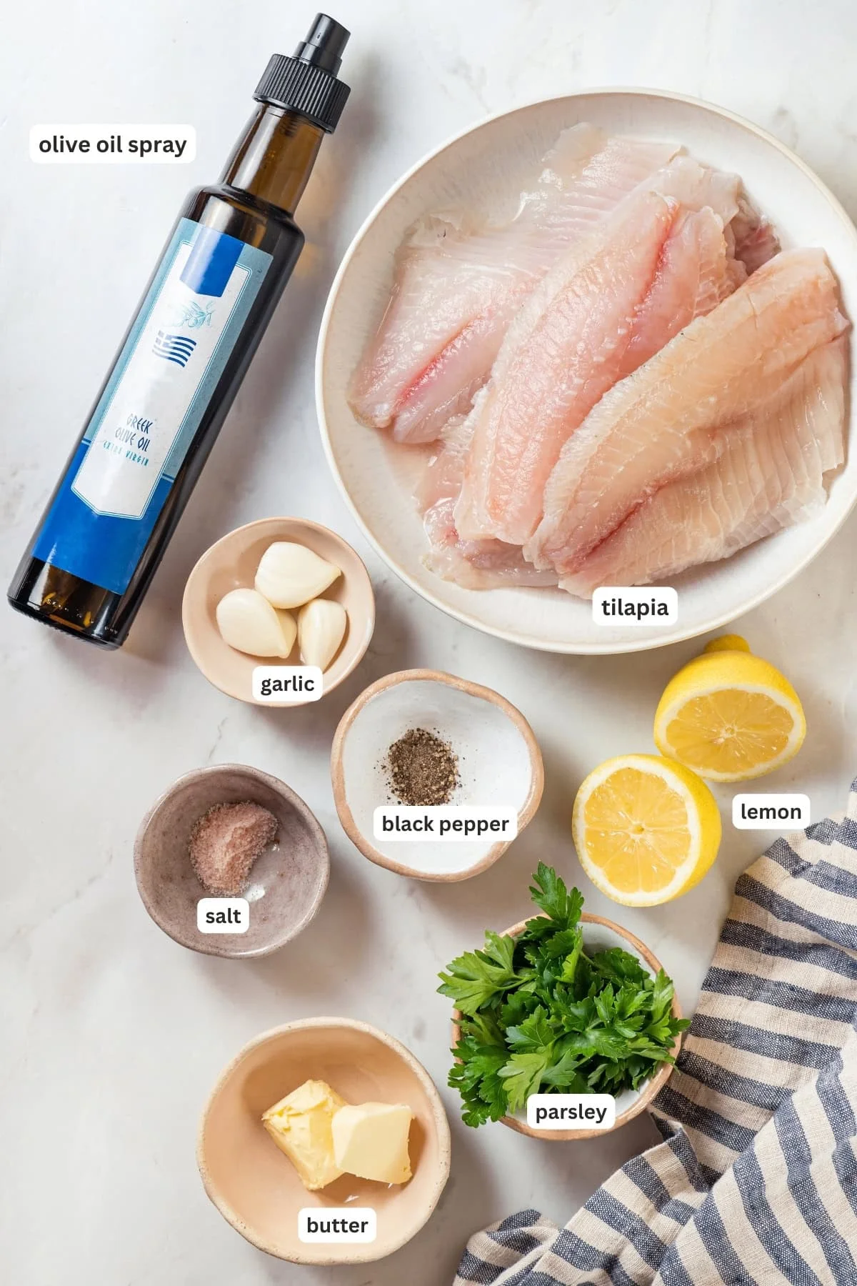 Overhead view of ingredients for baked tilapia with labels
