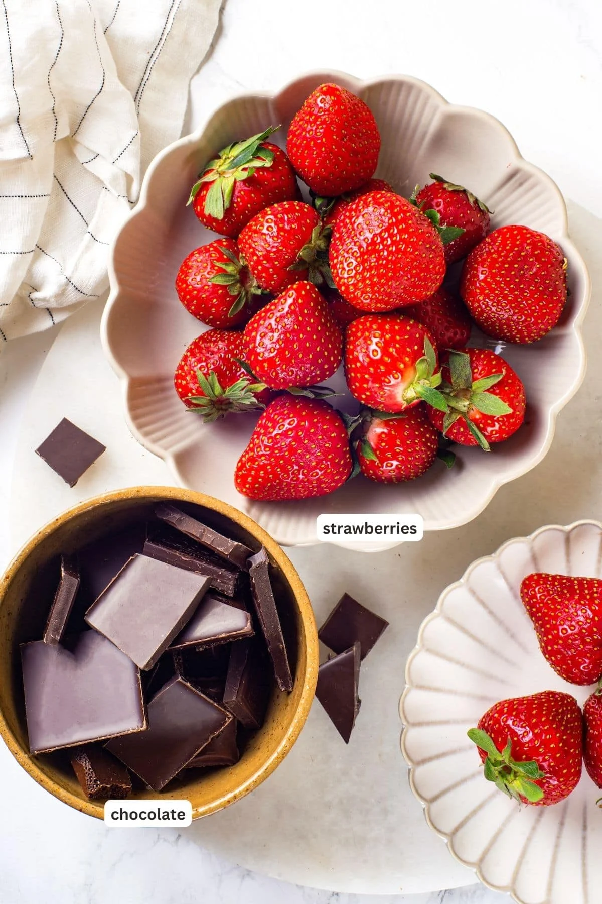 Overhead view of ingredients for chocolate-covered strawberries with labels