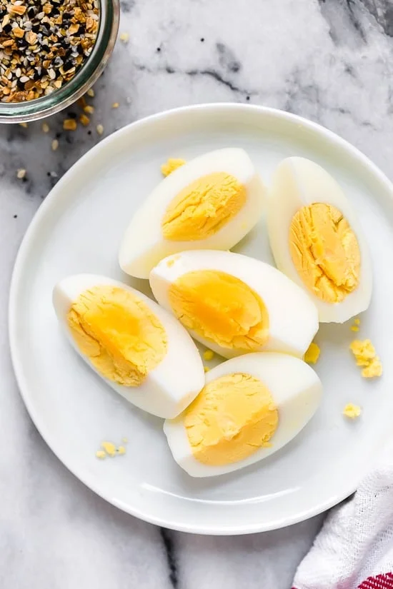 Overhead view of quartered hard boiled eggs on plate
