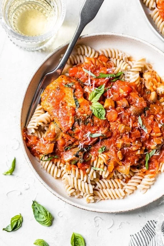Overhead view of rustic chicken cacciatore served over pasta.