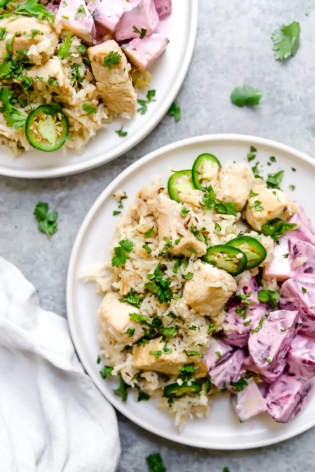 Overhead view of two plates of chicken pulao