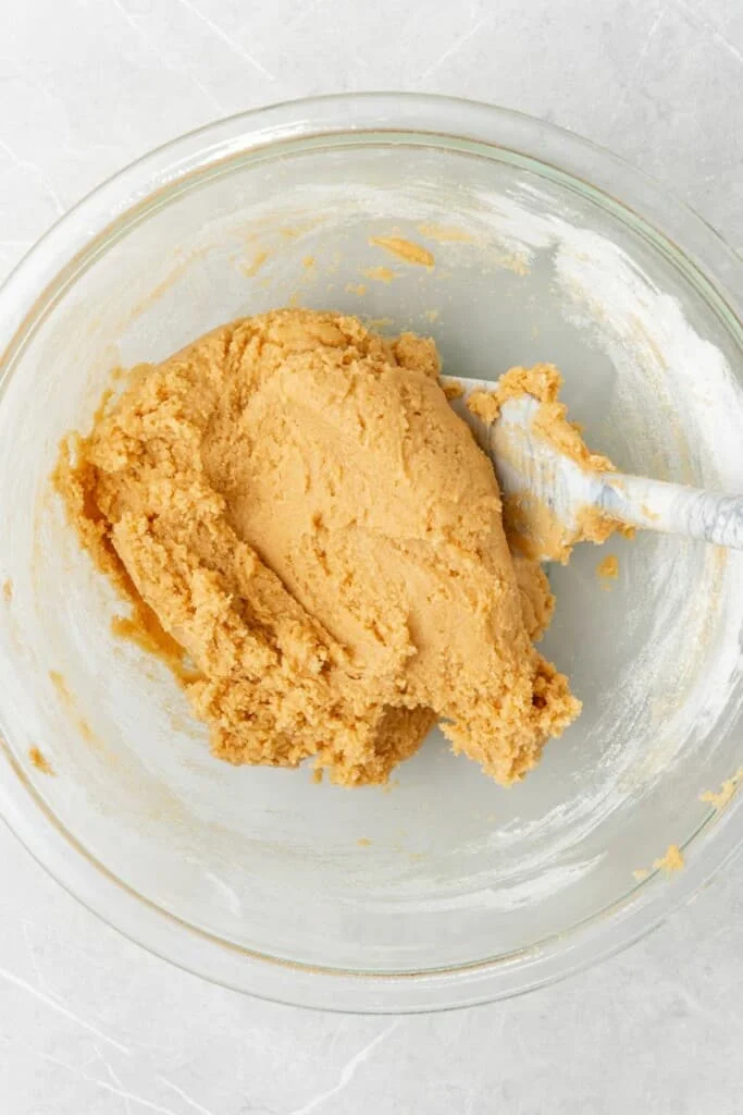 peanut butter cookie batter in a glass bowl 