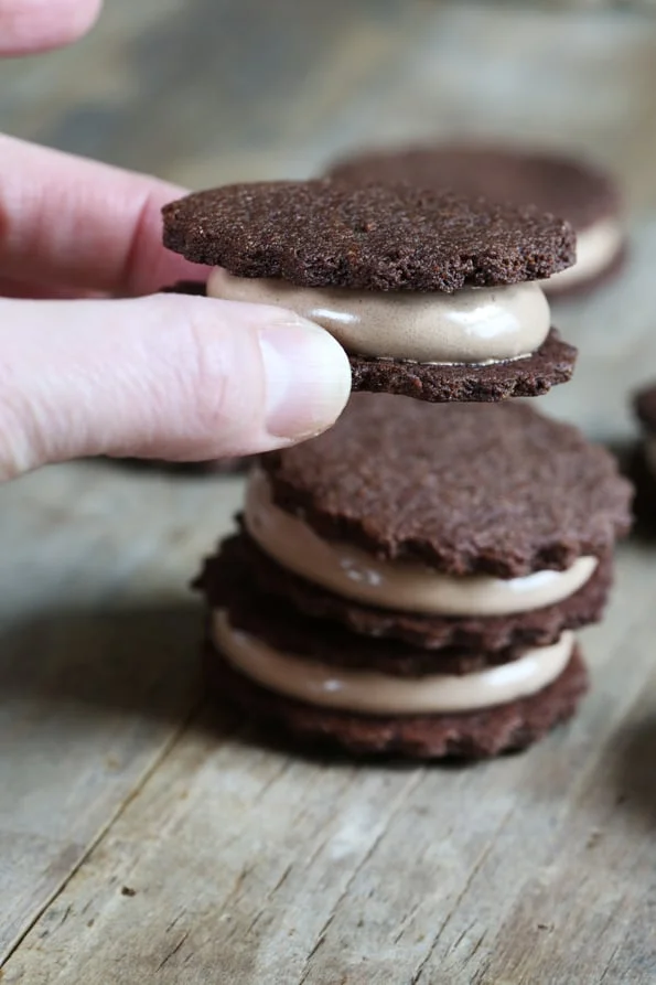 Person holding Oreo style cookies with filling