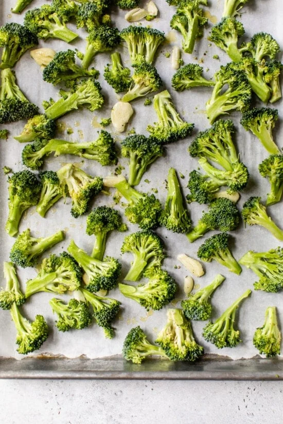 Place broccoli florets, smashed garlic, olive oil, salt and pepper on a sheet pan.