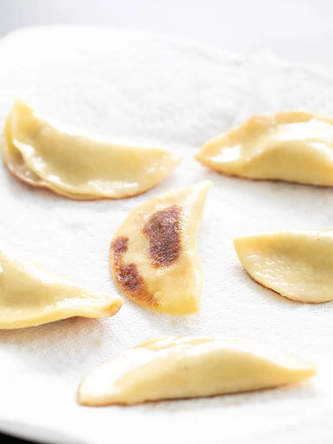 Potstickers draining on paper towels