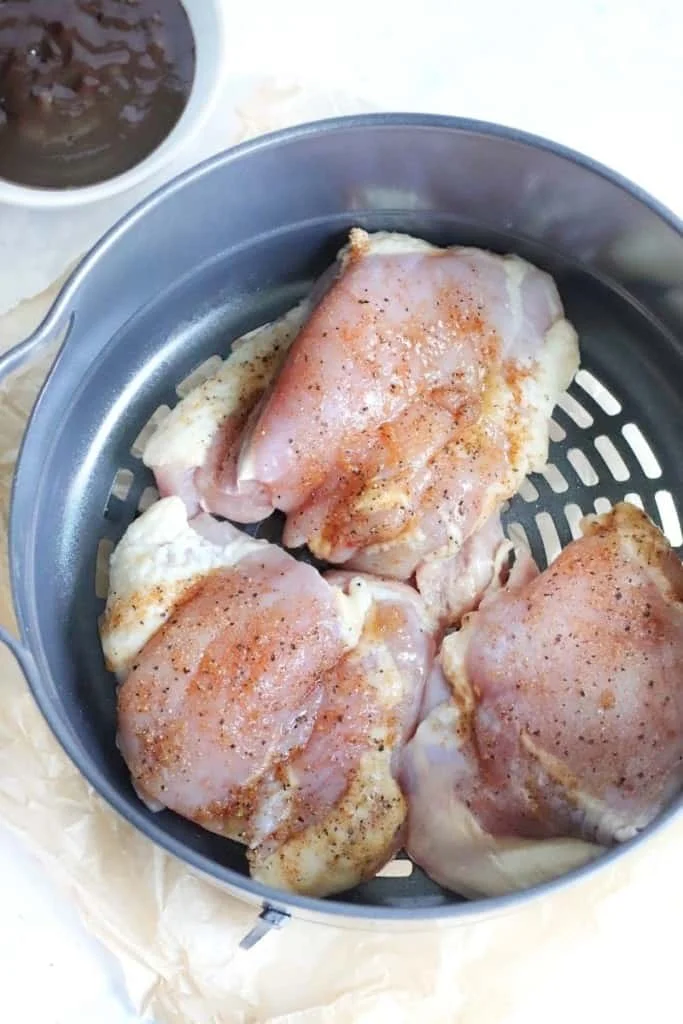 Raw chicken thighs in Ninja Foodi basket