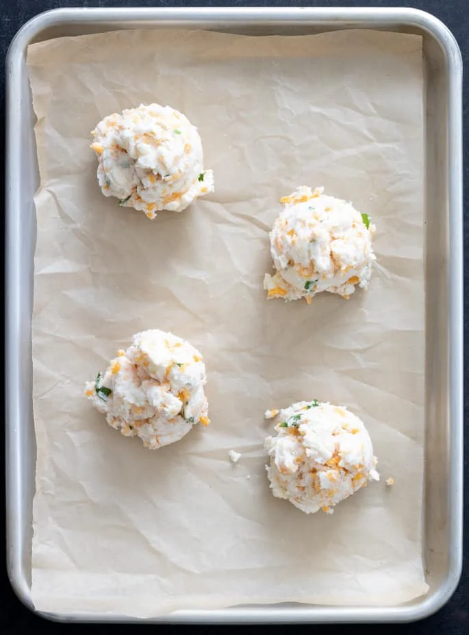 Raw mounds of gluten free cheddar bay biscuits, overhead image