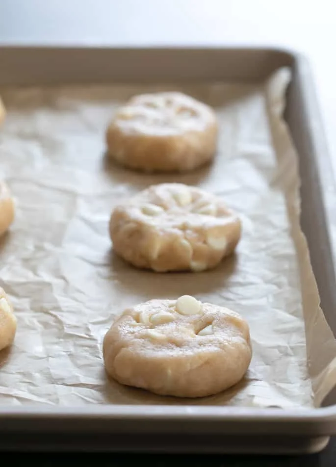 Raw pieces of gluten free apple pie cookies on a tray.