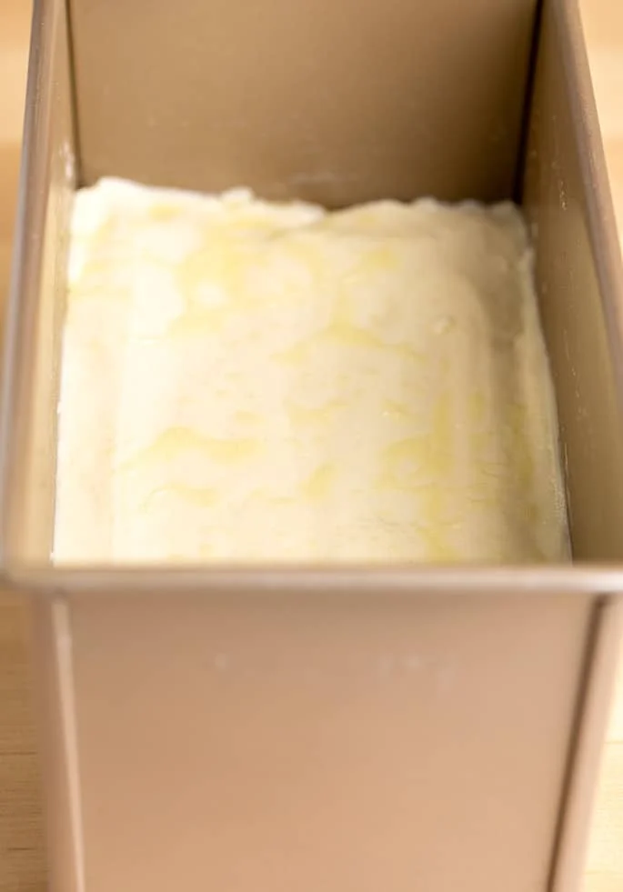 Raw potato bread dough in loaf pan.