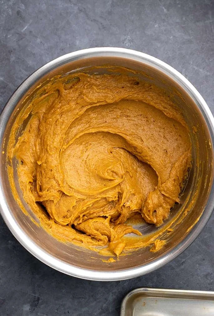 Raw pumpkin bar batter in large round metal bowl