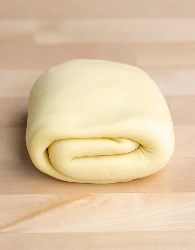 Raw unshaped gluten free pasta dough rolled up.