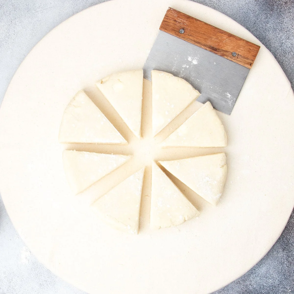 Round dough cut into 8 rectangles with metal bench scraper.