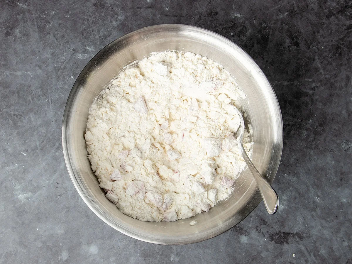 same bowl with chopped strawberries covered in flour ingredients, too