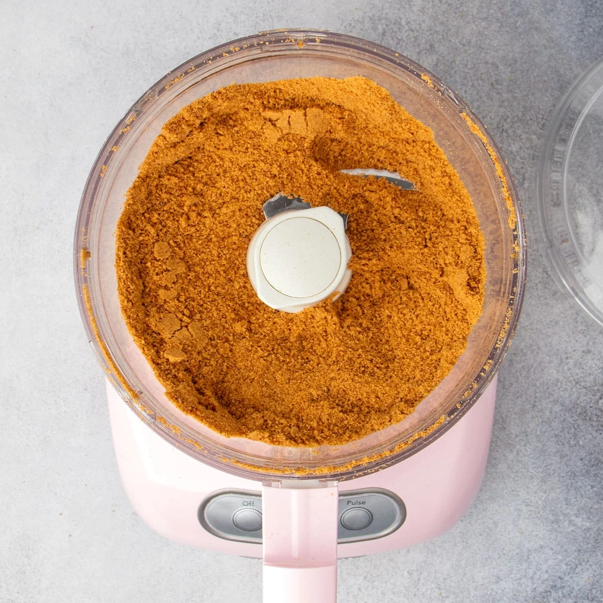 Same food processor with graham crackers processed into fine crumbs.