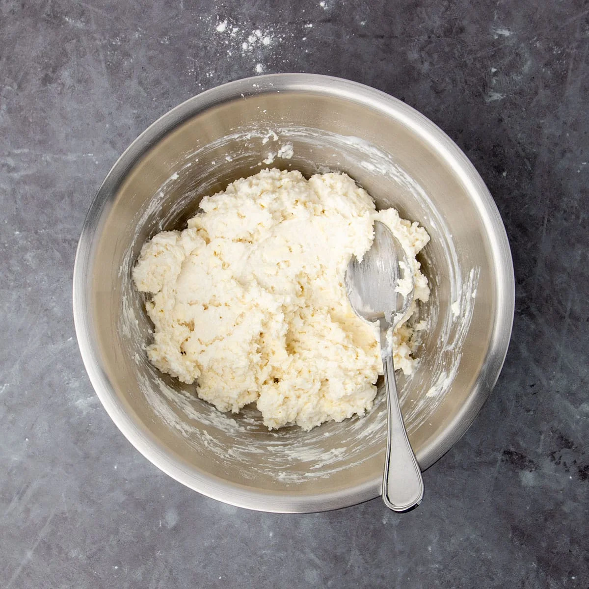 same mixing bowl with soft, craggy topping mixture after buttermilk was mixed in