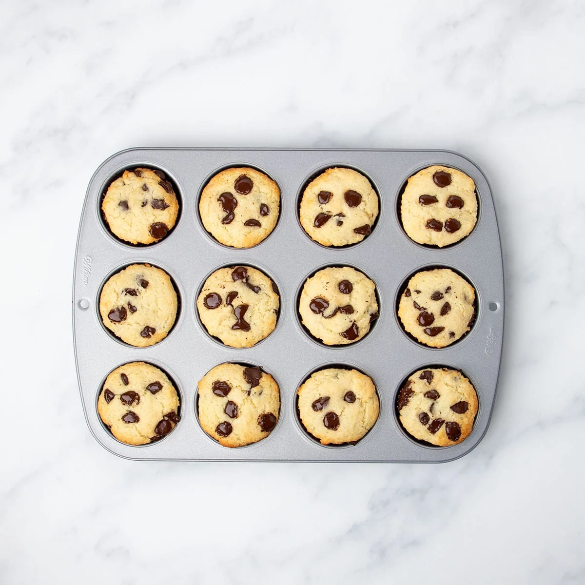 same muffin tin with all 12 muffins baked, still in wells of pan