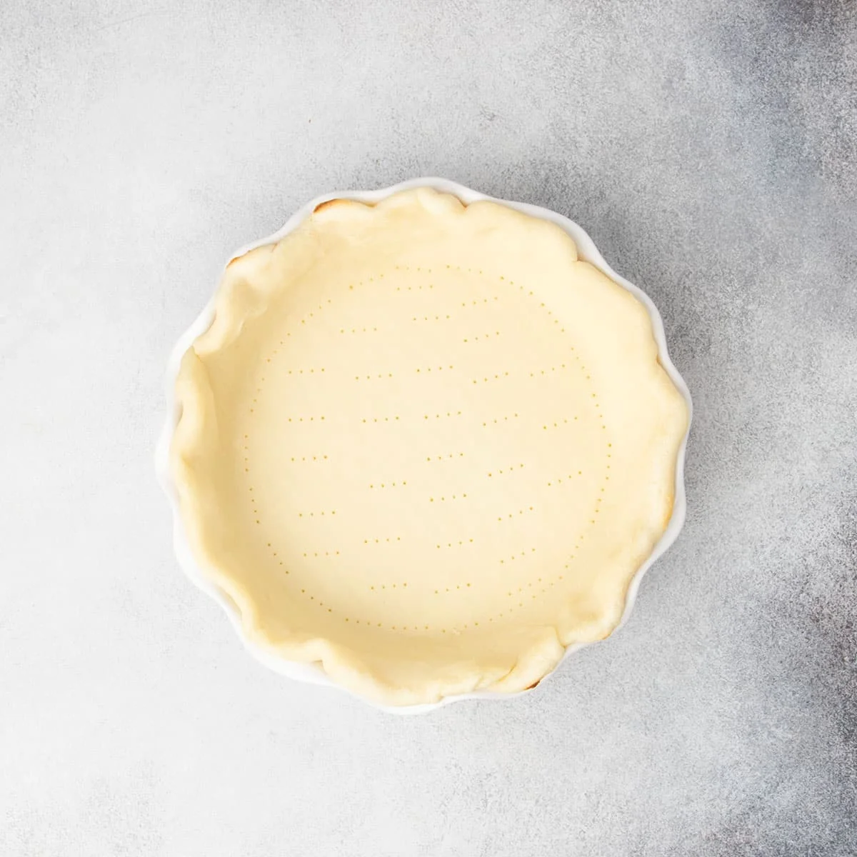 Same pie crust now lightly parbaked with some golden edges.