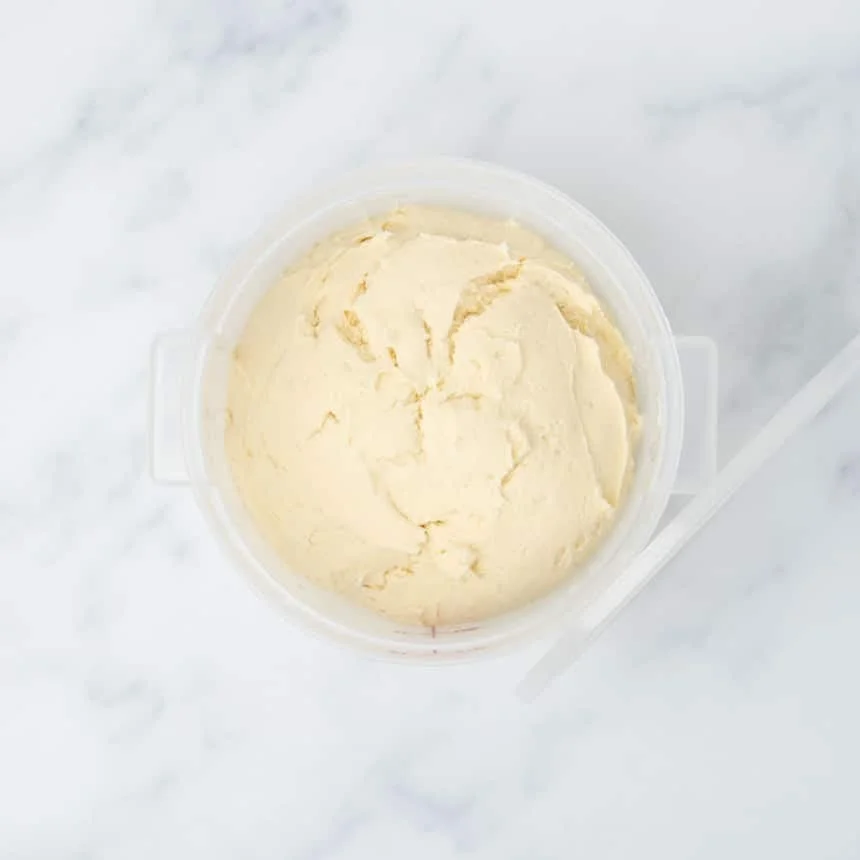 same raw dough in bucket after having risen
