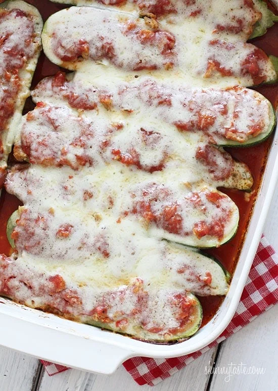 Sausage stuffed zucchini boats in casserole dish.