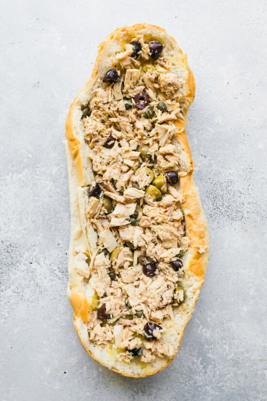 Scoop out the inside of the bread and brush with olive oil.