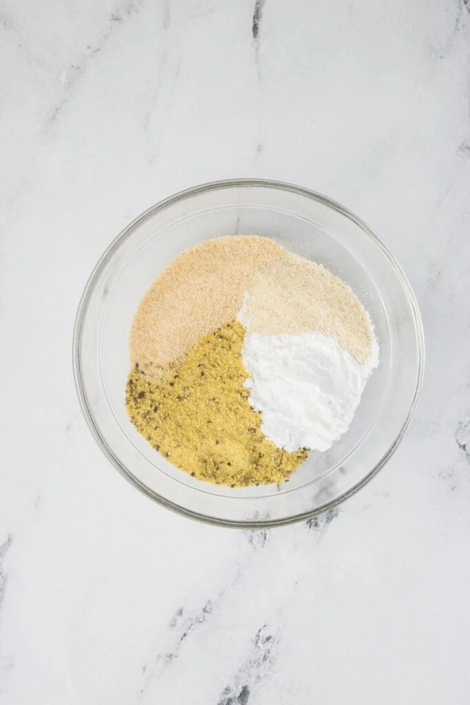 Seasonings for chicken wings in a small clear bowl.