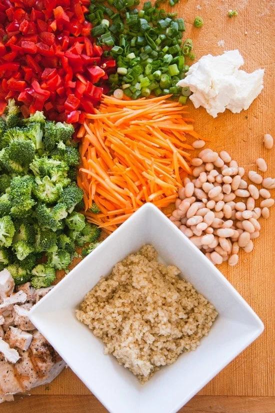 Seattle Sunshine Bowl – a bowl of goodness – quinoa, grilled chicken, white beans, chopped veggies, pumpkin seeds, feta, and scallions, all topped with a yellow Sunshine Sauce.