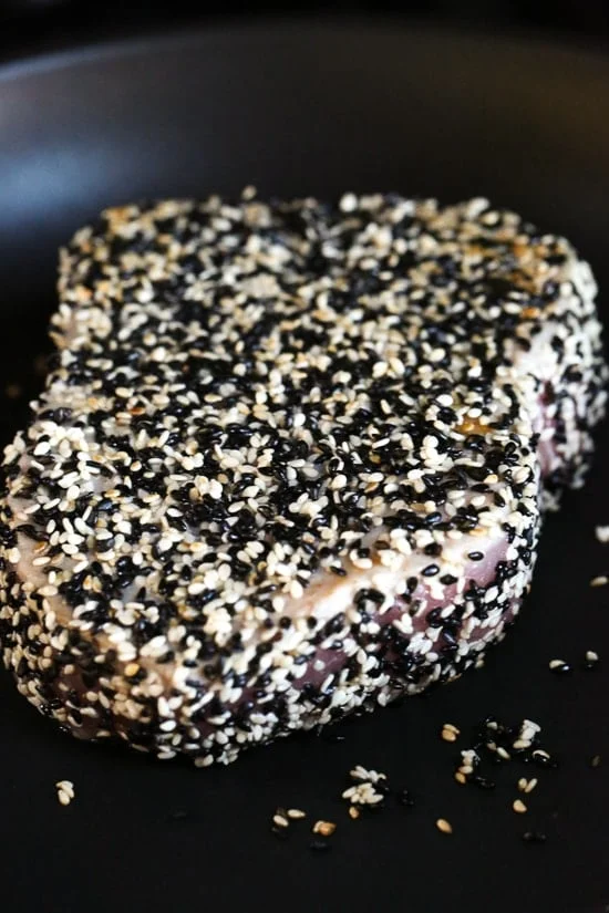 Sesame Crusted Tuna Steak on Arugula drizzled with a balsamic soy-ginger vinaigrette – yum!