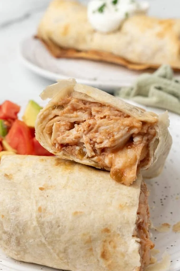 Shredded chicken mixture inside golden fried tortillas.