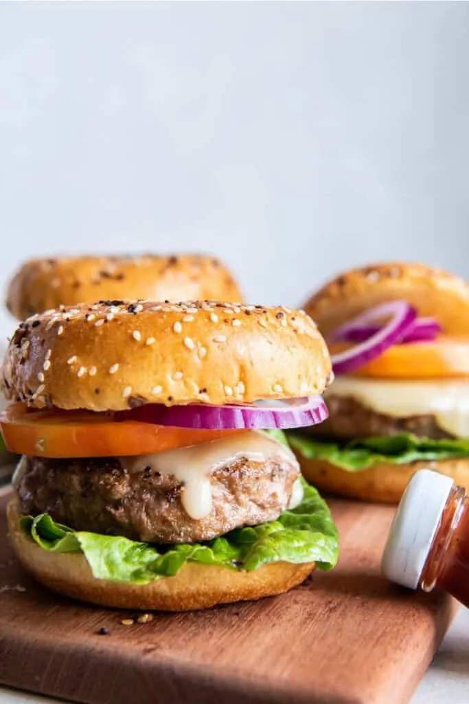 side view of frozen turkey burgers in air fryer. 