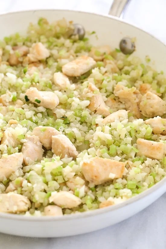 Skillet Cheesy Chicken and Veggie "Rice" made with riced broccoli and cauliflower, sauteed chicken and cheddar cheese. It's so fast and easy to make!