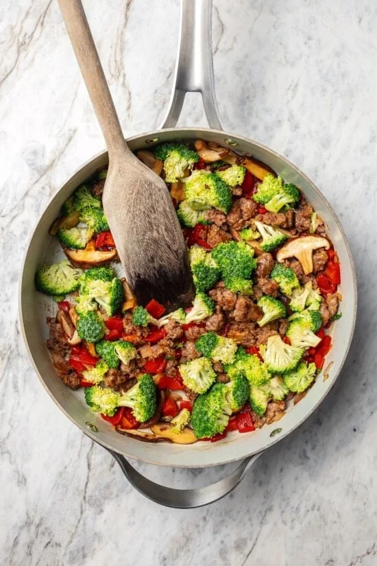 Skillet of vegetables and sausage.