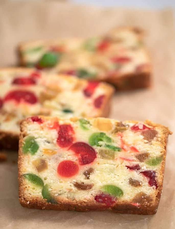 slices of white fruit cake with one closeup