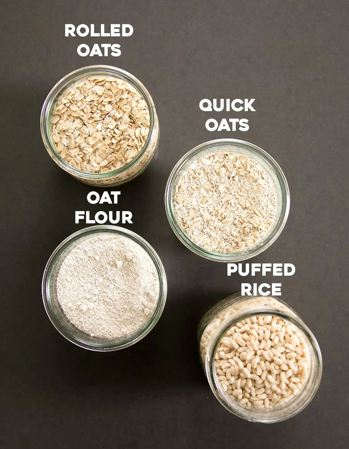 small bowls and glass jars with rolled oats, quick oats, oat flour and puffed rice