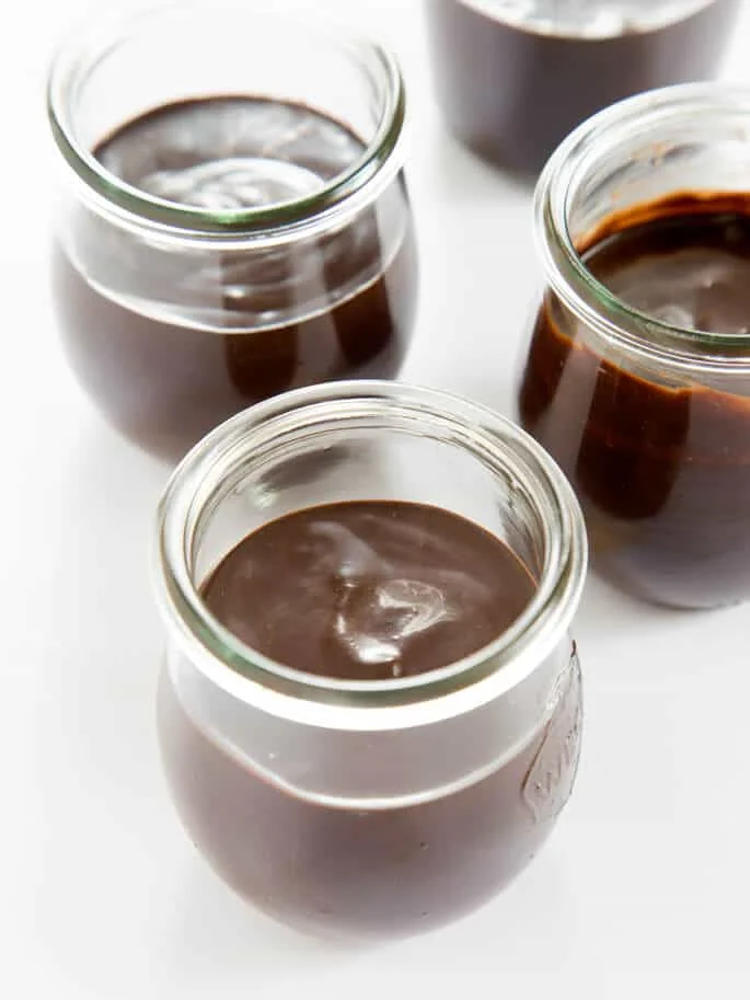 Smooth and creamy Paleo chocolate mousse, made with chocolate, coconut cream, cocoa powder, honey and vanilla. Just blend it and let it set. So rich & delicious! https://glutenfreeonashoestring.com/ 
