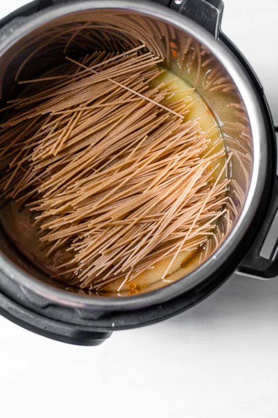 Spaghetti added to broth in instant pot.