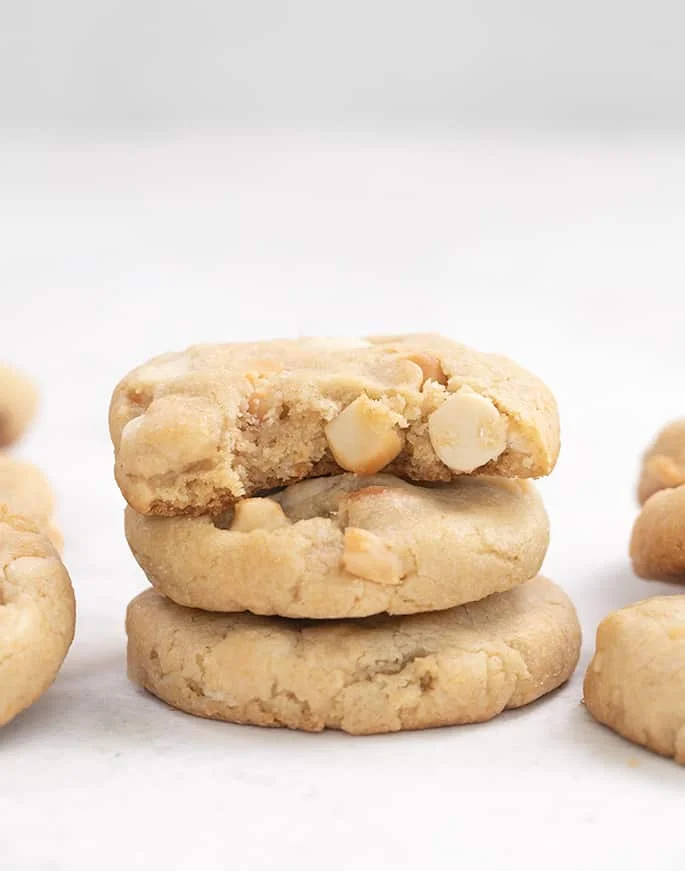Stack of 3 white chocolate macadamia nut cookies.