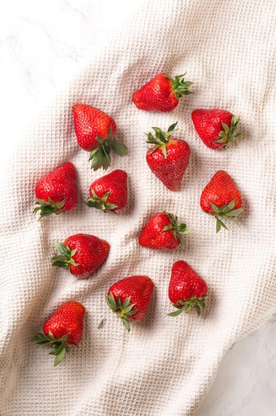 Strawberries drying on white kitchen towel
