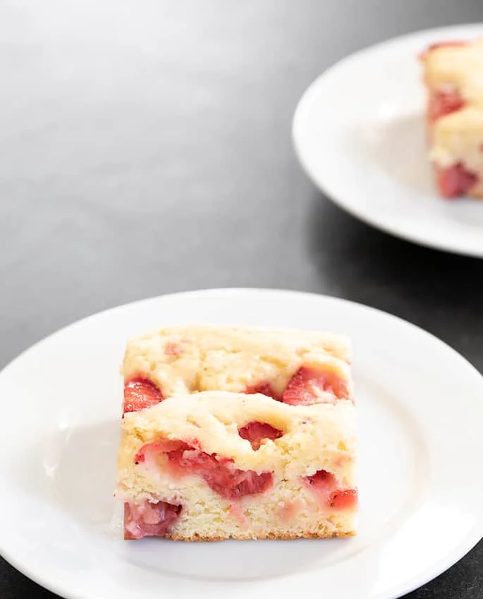Strawberry breakfast cake pieces served on two plates
