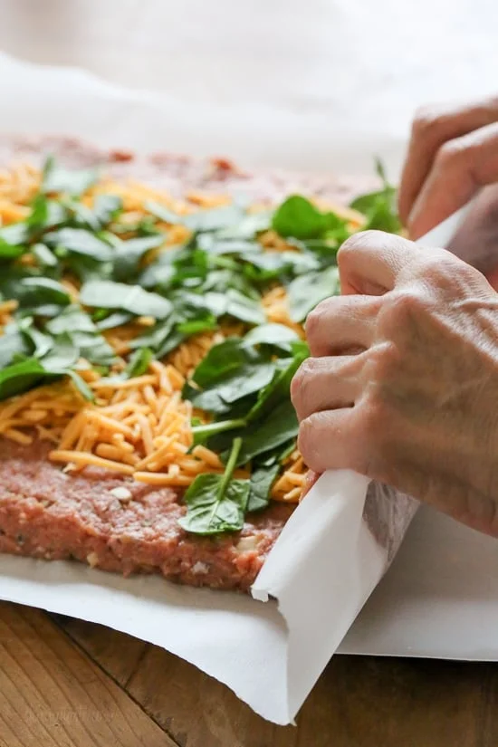 The best tasting, moist turkey meatloaf stuffed with cheddar cheese, spinach and rolled, jelly roll style topped with a ketchup based glaze. 