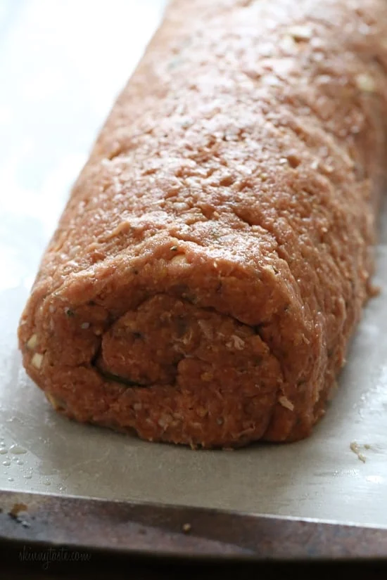 The best tasting, moist turkey meatloaf stuffed with cheddar cheese, spinach and rolled, jelly roll style topped with a ketchup based glaze. 