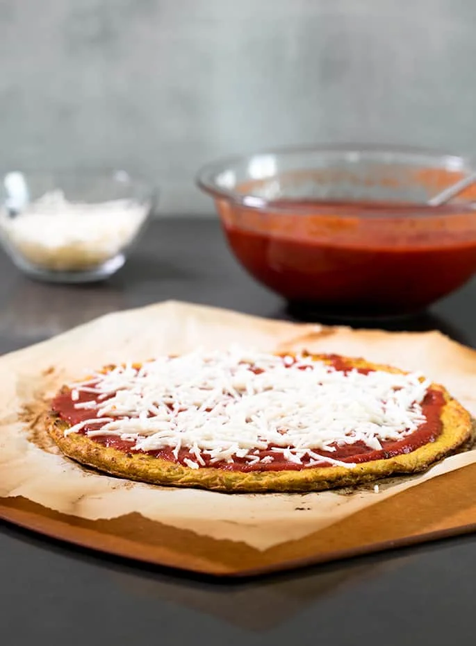 The crust with cheese and tomato sauce. 