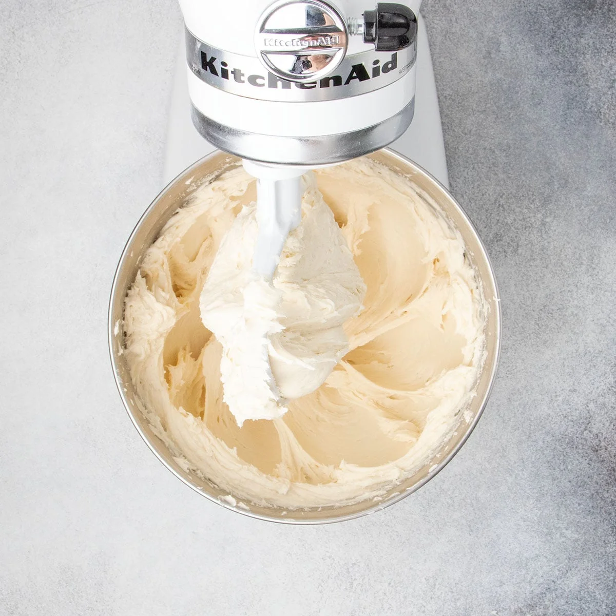 The dough being mixed in a stand mixer until smooth and fluffy.